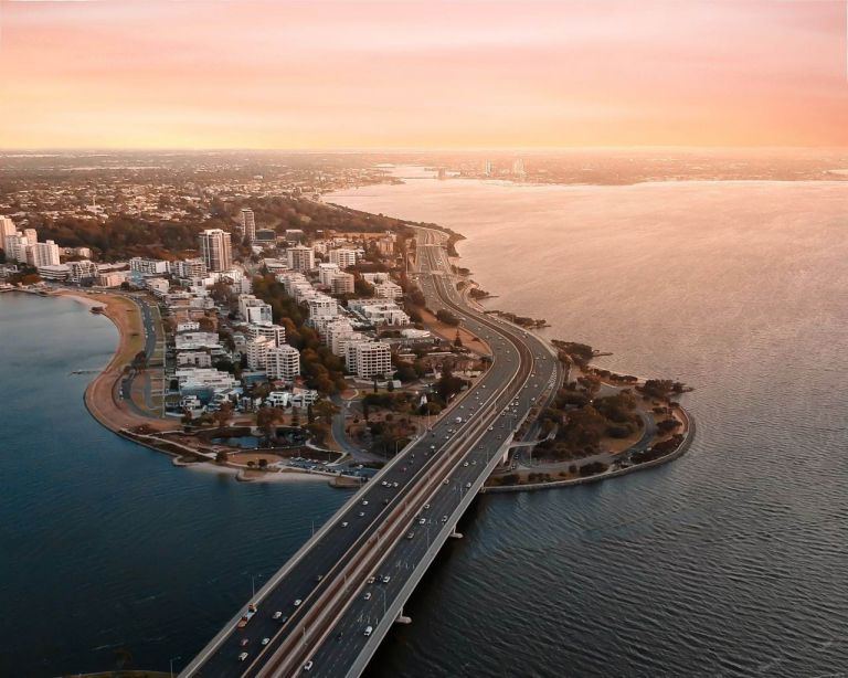 High density housing along the isthmus in Perth, Australia. The image is taken at golden hour as seen by the pink lit sky and ocean
