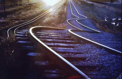 Historic image of a railway now permanently bent into a wiggled shape, still in parallel, though unusable, as a result of the Meckering earthquake in 1968.