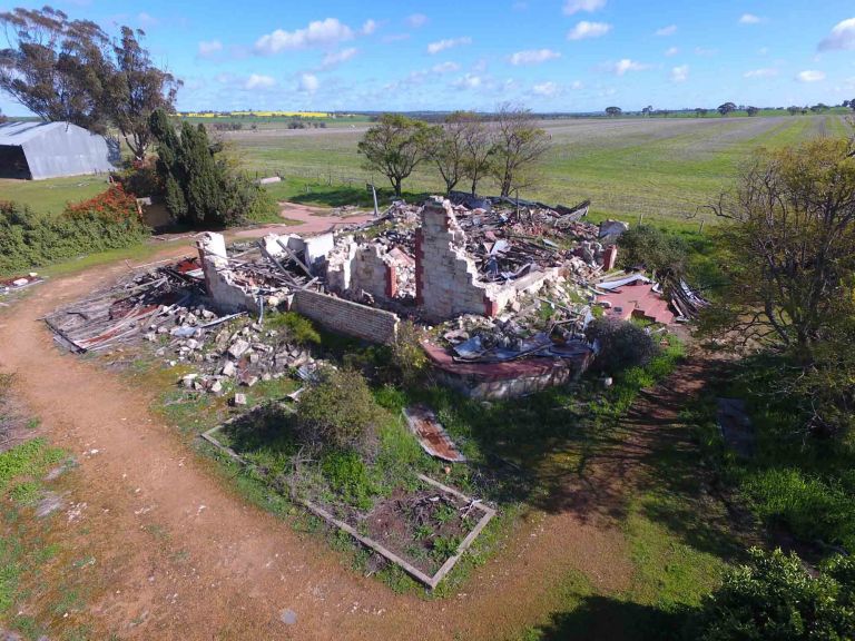 The remaining frame of a house that has fallen from an earthquake