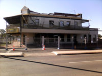 Fig 2.  Damage caused to a hotel in Boulder. The damage is typical for  two storey unreinforced masonry buildings with toppling of parapets either outwards into the street or inwards through the roof.  