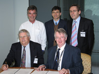 Fig 1.  Ted Stapinski (Director, ASI) and Neil Williams (CEO, Geoscience Australia) signing the SHRIMP purchase contract.