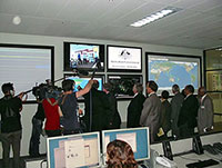 Fig 1. Minister and guests checking monitors showing earthquake activity following opening of the Centre. 